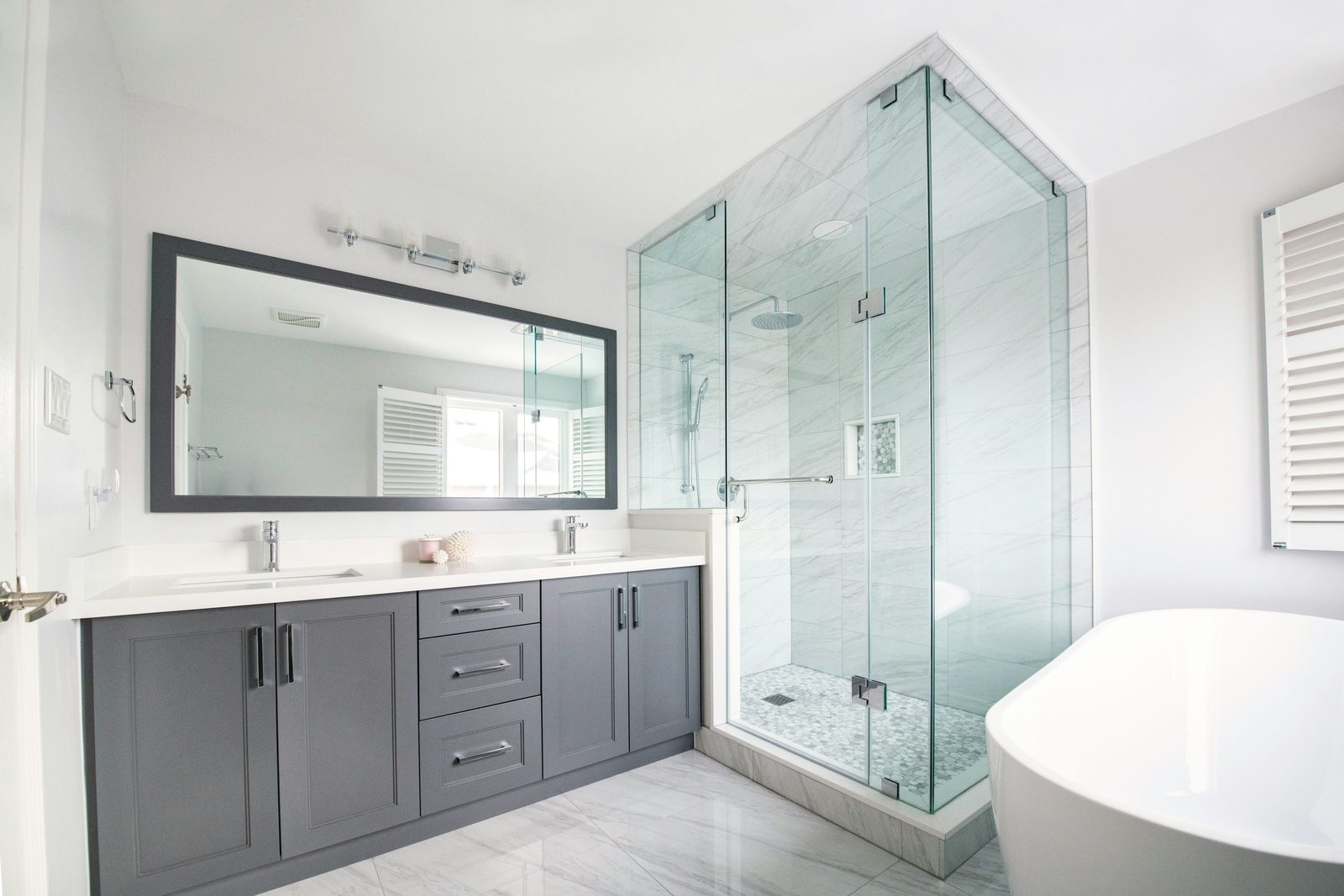 Fully renovated Bay Area bathroom with a new vanity, glass walk-in shower, and freestanding tub