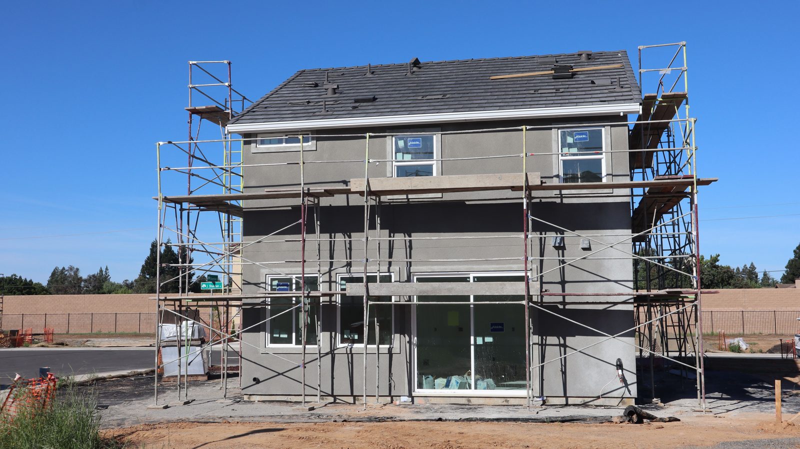 Two-story Bay Area home mid-renovation with exterior scaffolding during a remodel